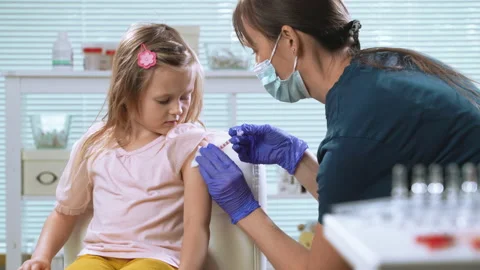 Female nurse vaccinating child Stock Footage 219577341