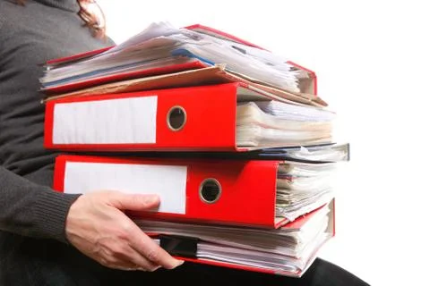 Female office worker carrying a stack of files Stock Photos