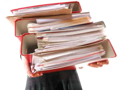 Female office worker carrying a stack of files Stock Photos