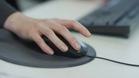 Female Office worker clicking on computer mouse - 8k Stock Footage 142902296