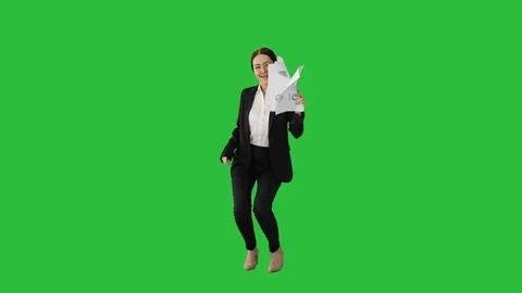 Female office worker dancing with paper documents on a Green Screen, Chroma Key. Stock Footage 125456959
