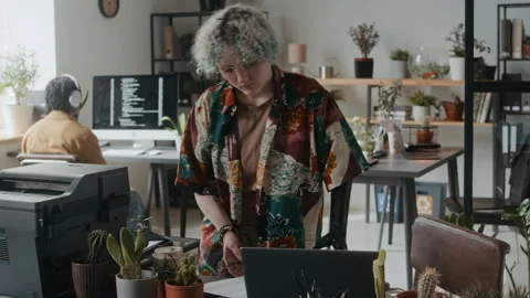 Female Office Worker Examining Printed Document and Using Laptop Video stock 306210568