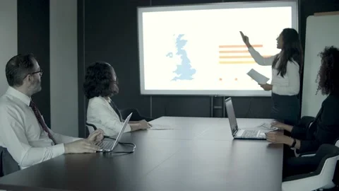 Female office worker explaining data and pointing to charts Stock Footage 137513540