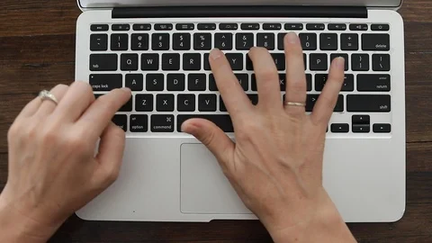 Female office worker typing on the keyboard Stock Footage 127795680