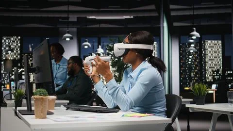 Female office worker using VR headset with artificial intelligence after hours Stock Photos
