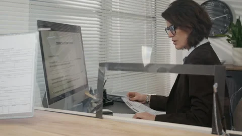 Female Officer Checking Documents of Visa Applicant at US Embassy Stock Footage 331507163