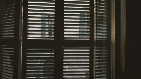 Female opens shutters of old window looking to the street of old Italian town Stock Footage 96783818