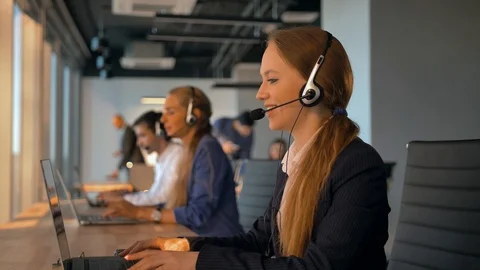 Female operator agent with headsets working in a call centre. Video stock 97066709