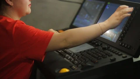 The female operator, the illuminator at the remote control, programs the stage Stock Footage 126660218