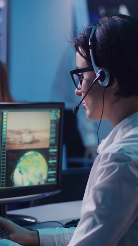 Female operator using computer to launch rocket in office Stock Footage 274383659