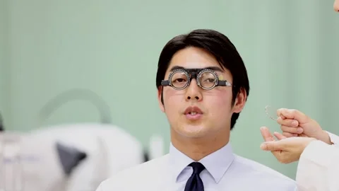 Female Ophthalmologist Adjusting Trial Frames During Male Patient Eye Test Stock-Footage 344237918
