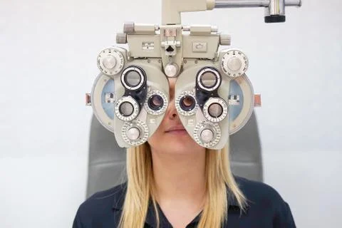 Female Optometrist Doing Sight Testing For female Patient In Clinic Stock Photos