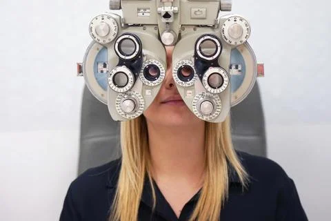 Female Optometrist Doing Sight Testing For female Patient In Clinic Stock Photos