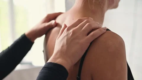 A female osteopath performs manual techniques and massage procedures on a female Vídeo Stock 344378320