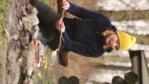 Female outdoors roasting marshmallows Stock Footage 231128743