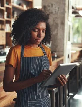 Female owner using digital tablet at the coffee shop Stock Photos