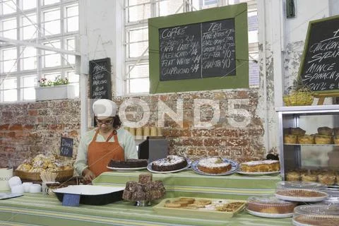Female Owner Working In Cake Shop Stock Photos