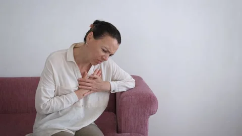 Female with pain touch breast indoor. Stock Footage 233120553