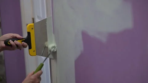 Female Painter Rolling Green Paint Over Purple Wall In Room Makeover 库存影片 345251442