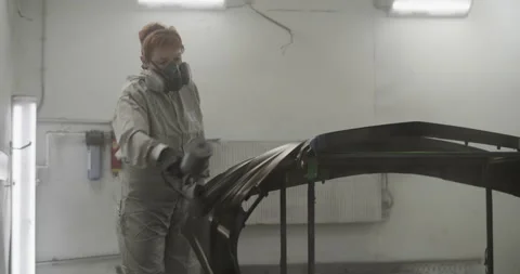 Female painter working on bumper in professional workshop Stock Footage 227170928