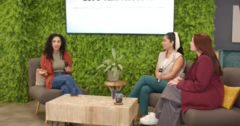 Female panelists prompted by Let's Talk About AI slide exchanging mics, sharing Видео 340147334