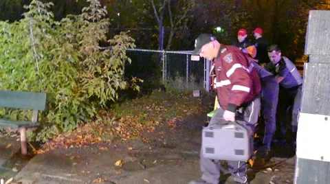 Female paramedic doing CPR while standing on high-tech ambulance stretcher Stock Footage 43312059