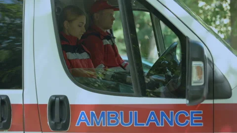 Female paramedic using smartphone to call patient, ambulance crew on-duty 스톡 동영상 97038750