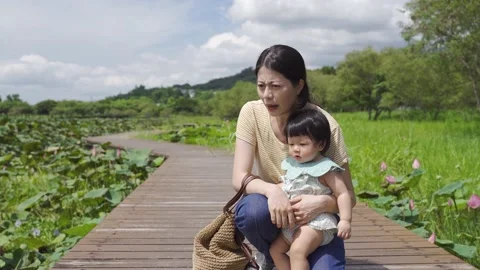 Female parent gesturing at the plants Video stock 158674102