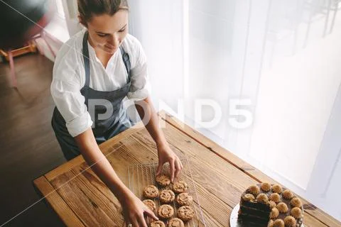 Female pastry chef preparing cookies Stock Photos