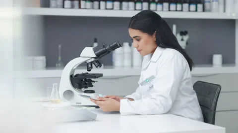 Female pathologist analyzing medical samples while doing experiments to develop Stock Footage 201642077