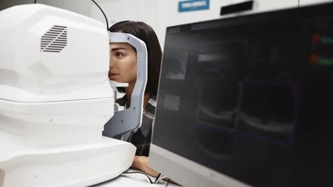 Female patient undergoing optical tomography examination using a digital OCT Stock Footage 337288246