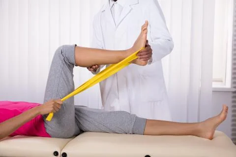 Female Patient Using Ribbon While Doing Exercise Foto stock