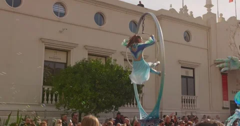 Female performer balancing on a cable during the Fête du Citron parade in Stock Footage 331615401