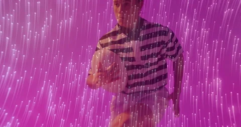 Female performer stepping into pink tech light installation and cradling, Stock Footage 312467655