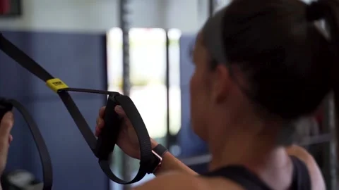 Female performing cable pull ups in gym Stock Footage 141902804