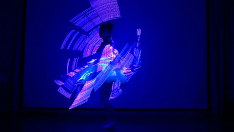 Female performs LED show at night. Stock Footage 69870834