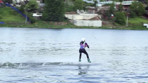 Female performs a successful jump from a springboard into the water on a wake Stock Footage 76835798