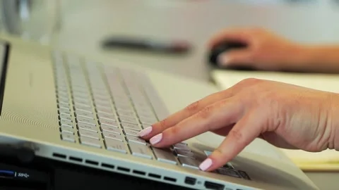 A female person using a lap-top keyboard and mouse Stockbeeldmateriaal 156783675