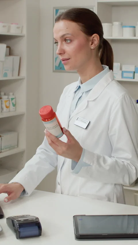 Female Pharmacist using PC Vertical Stock Footage 334877202