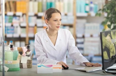 Female pharmacist working at computer in pharmacy Stock Photos