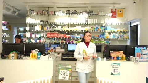 Female pharmacist working inside a pharmacy Stock Footage 336690291