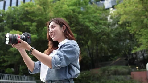 Female Photographer Adjusting Camera Before Taking Photos Outdoors Stock Footage 341661131