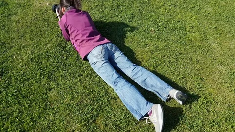 Female photographer using DSLR camera on grass Stock Footage 92691271
