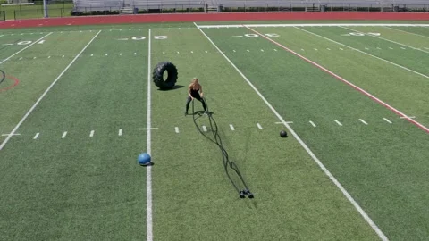 Female Physical Trainer Working Out Cross Fit Conditioning Ropes Aerial Drone Stockbeeldmateriaal 154384375