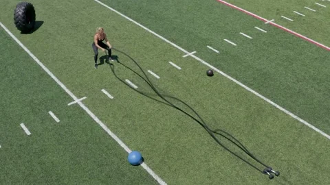 Female Physical Trainer Working Out Cross Fit Conditioning Ropes Aerial Drone Vidéo 154384376