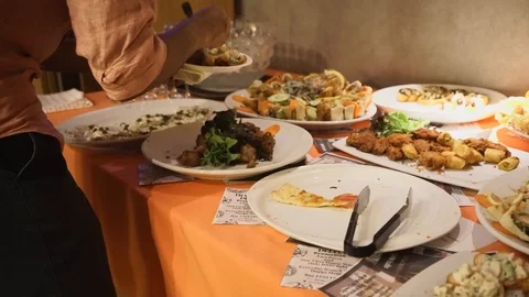 A female pick up the food from the buffet table Stock Footage