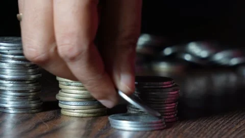 A female is placing coins for saving Stock Footage 314613085