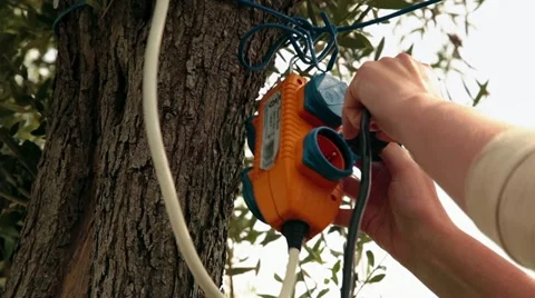 Female Plugging Power Cable in the Nature Video stock 11153975
