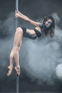 Female pole dancer posing in dark studio 스톡 사진