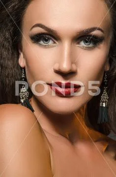 Female portrait in the studio, the glare from backlight. Stock Photos